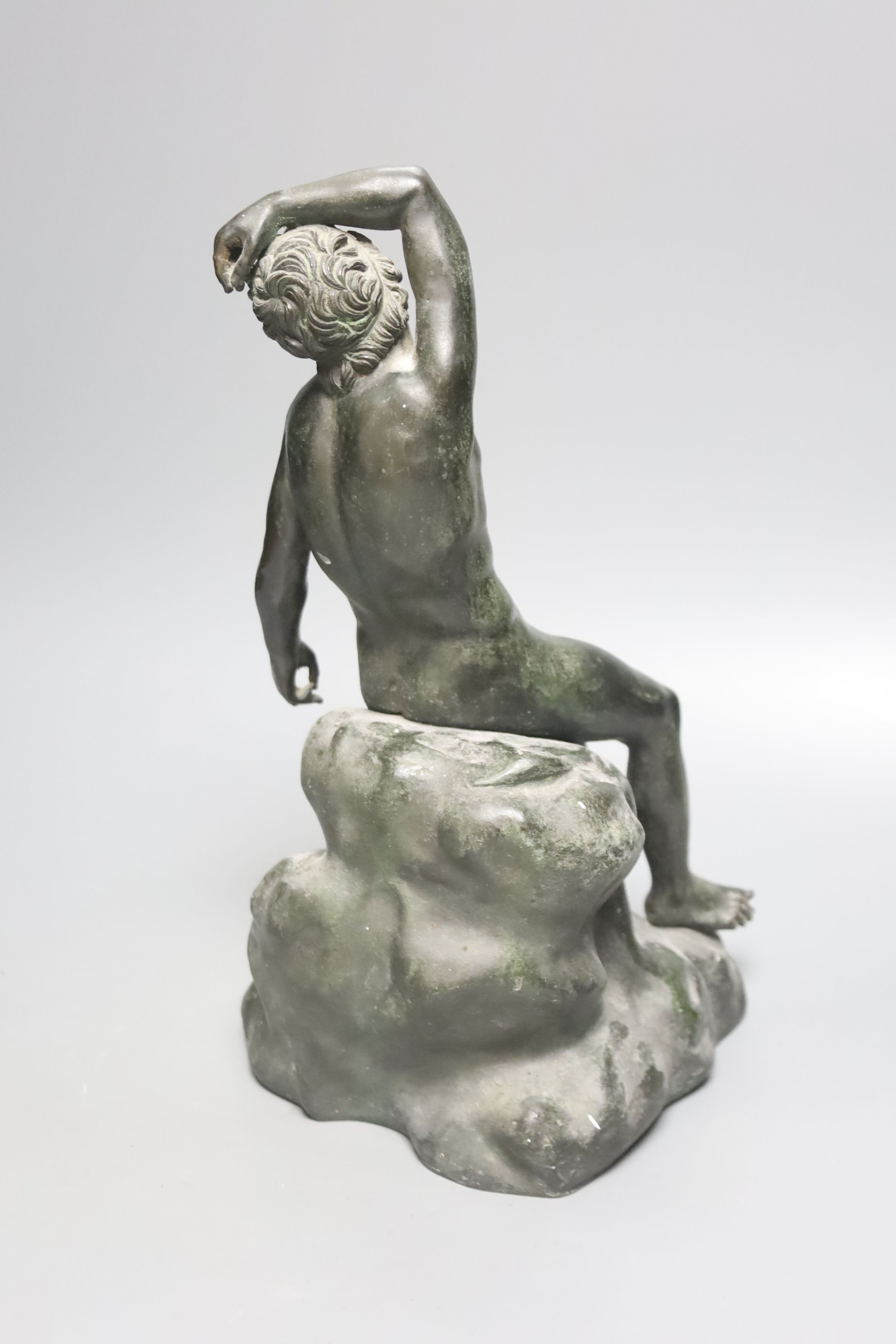 After the Antique a bronze figure of a man seated on a rock, height 34cm